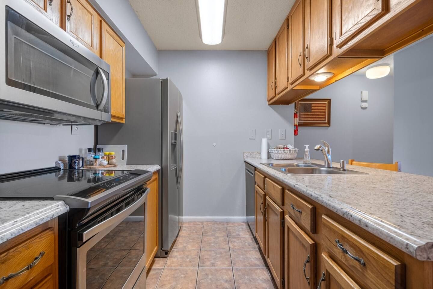 A kitchen with stainless steel appliances and wooden cabinets