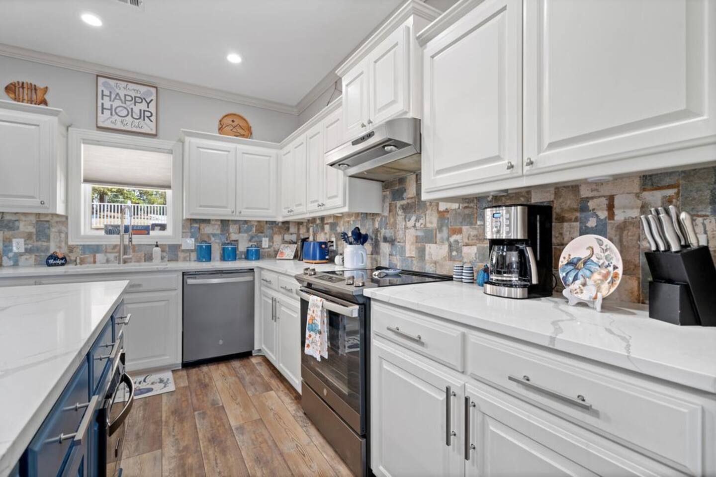 A kitchen with white cabinets and stainless steel appliances.