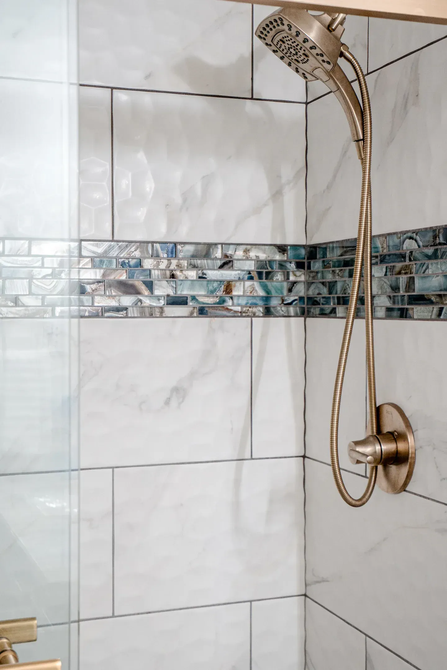 A close up of a shower head in a bathroom.