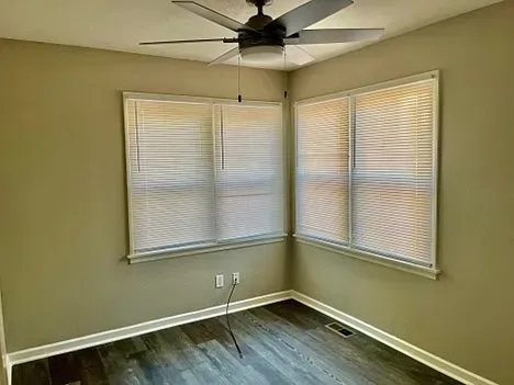 There is a ceiling fan in the corner of the room.