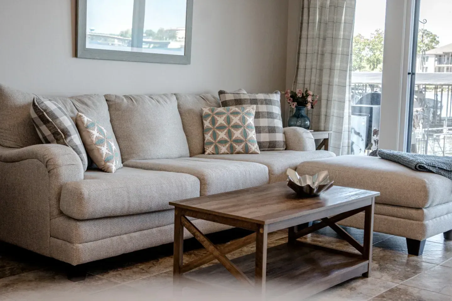 A living room with a couch , coffee table , and mirror.