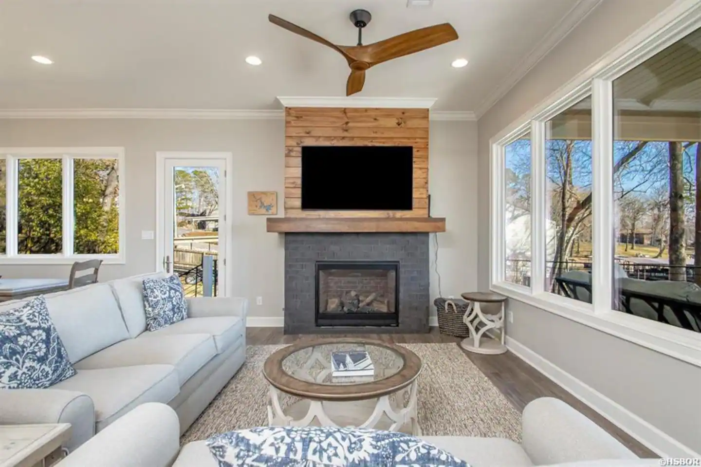 A living room with a fireplace and a flat screen tv.