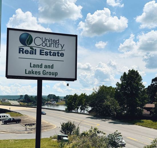 A sign for united country real estate land and lakes group