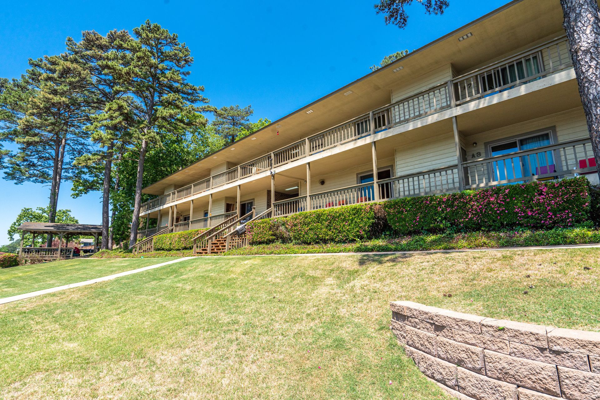A large building with a lot of balconies and trees in the background.