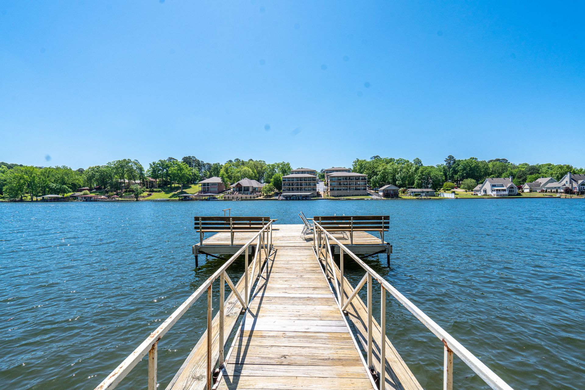 A wooden dock leading into a large body of water.
