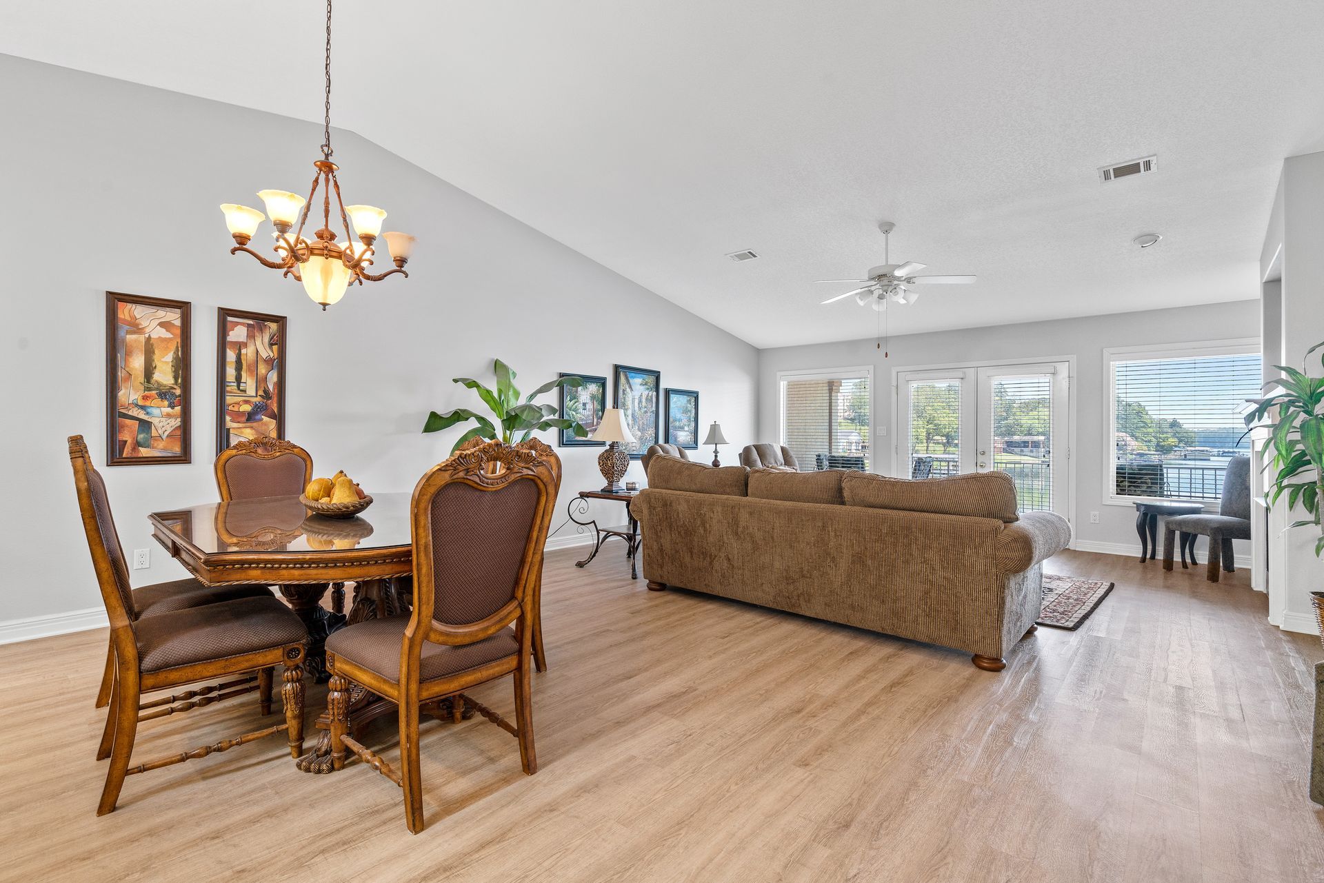 A living room with a dining table and chairs and a couch.