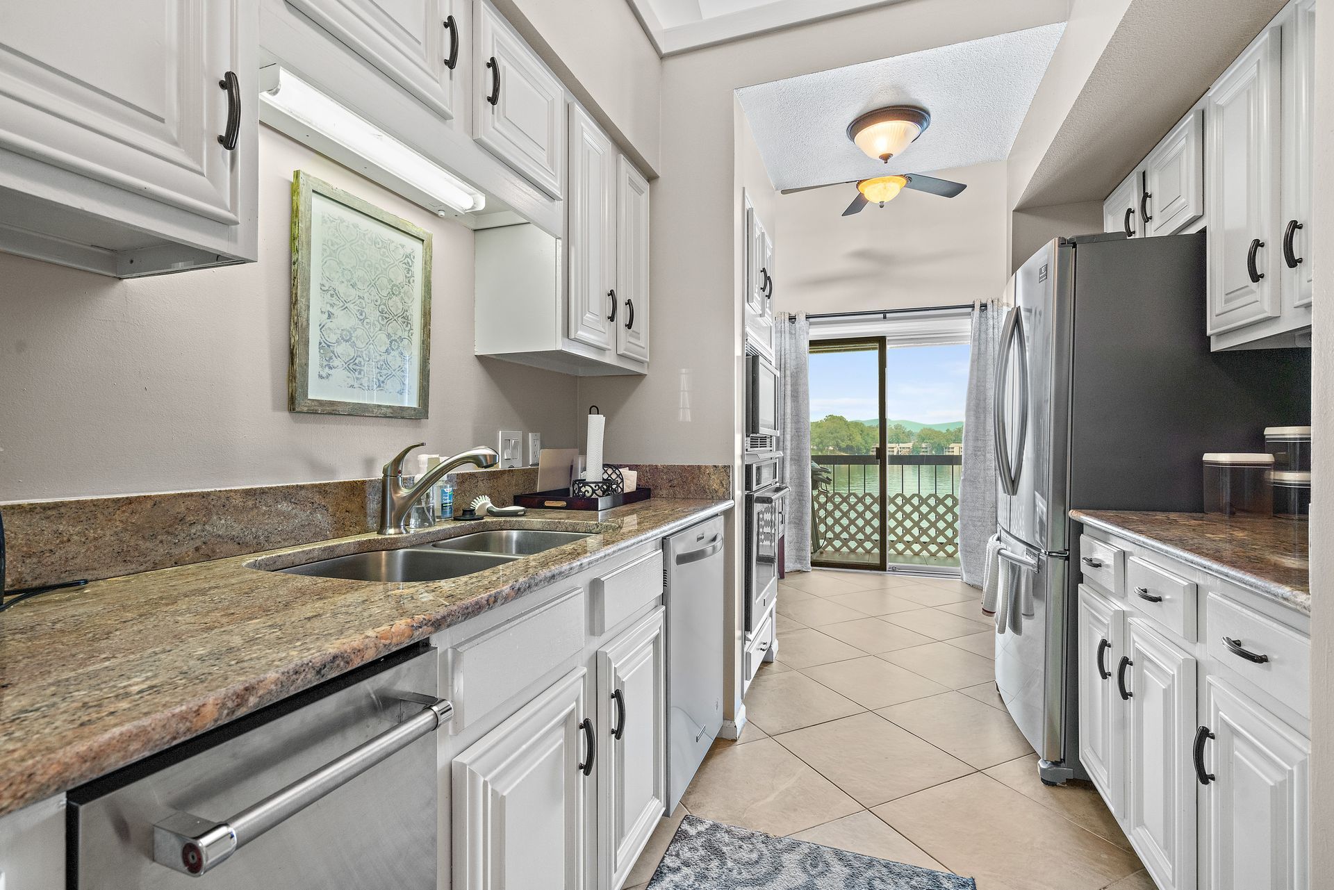 A kitchen with white cabinets and granite counter tops