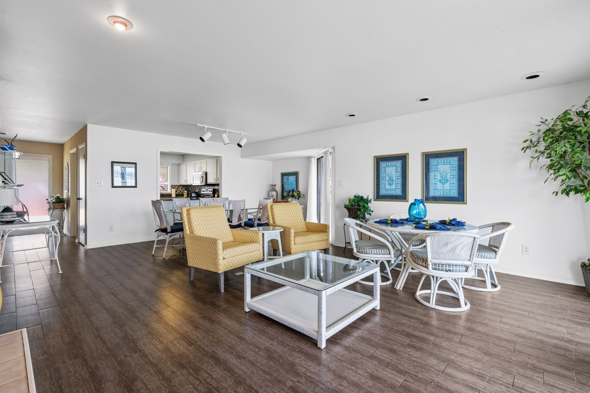 A living room with a table , chairs , and a coffee table.