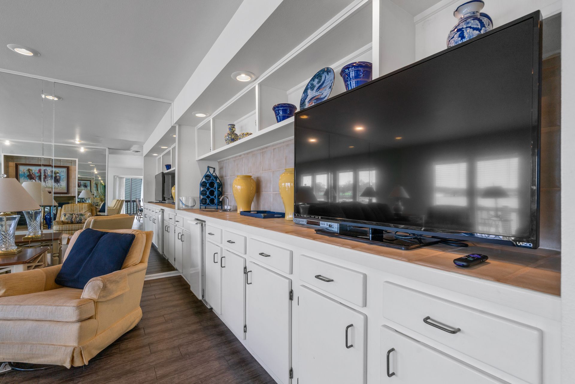 A living room with a large flat screen tv on the wall.