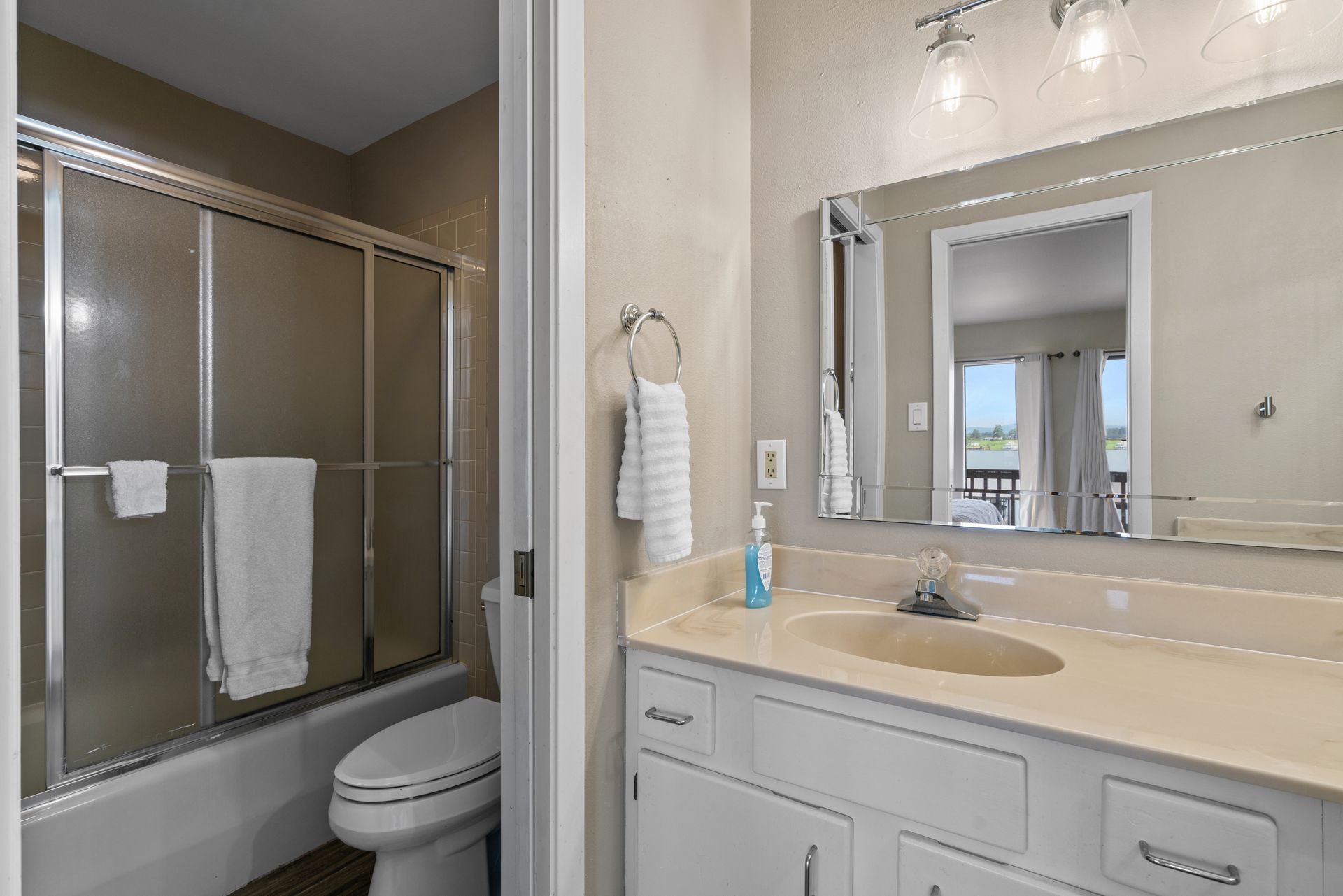 A bathroom with a toilet , sink , and shower.