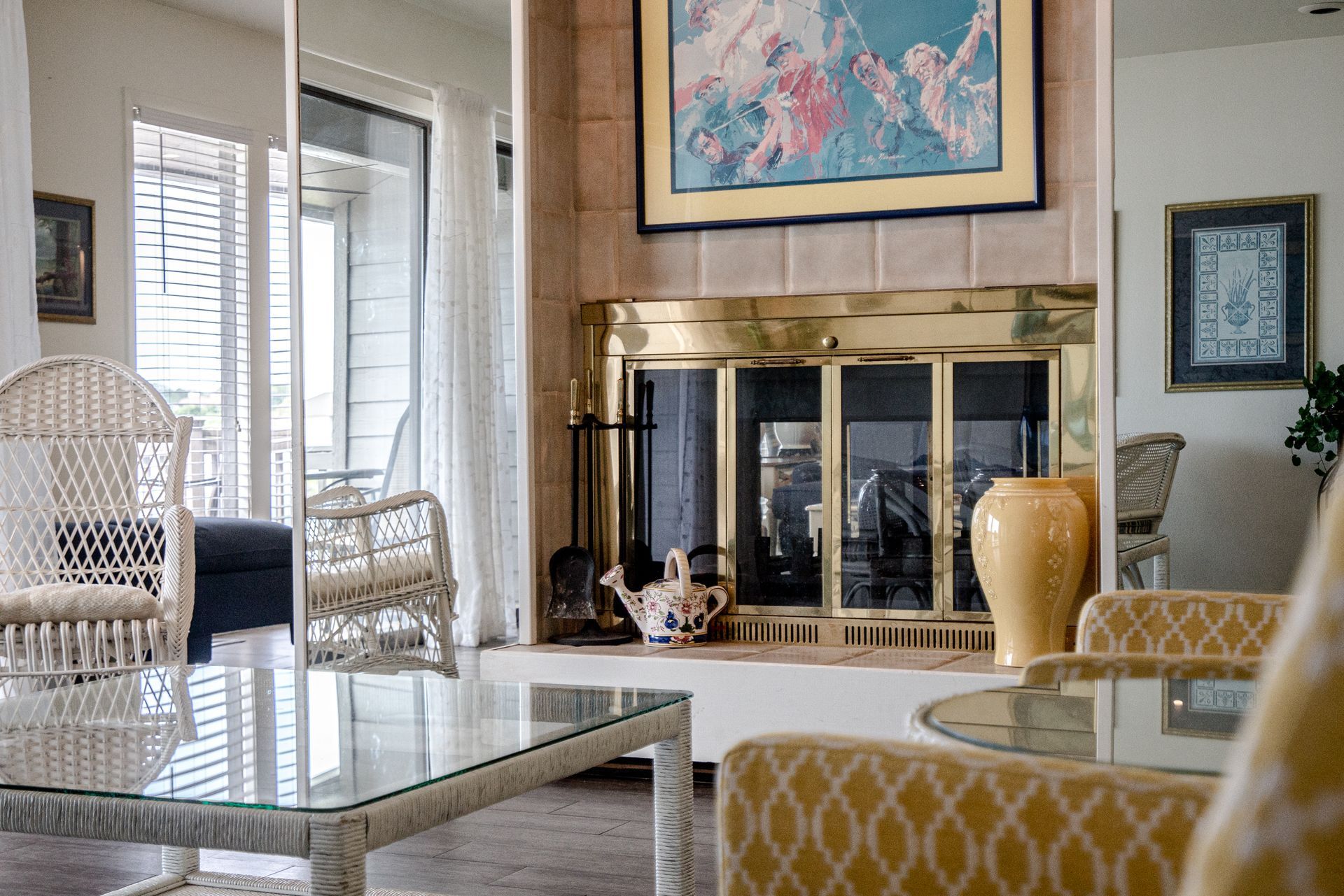 A living room with a fireplace and wicker furniture