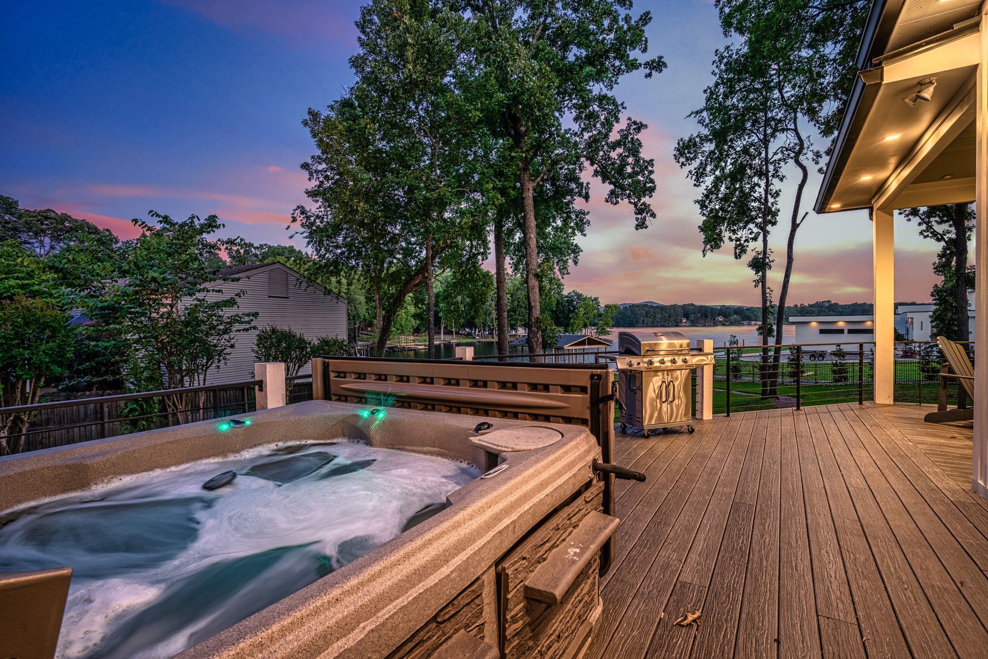 There is a hot tub on the deck of a house.