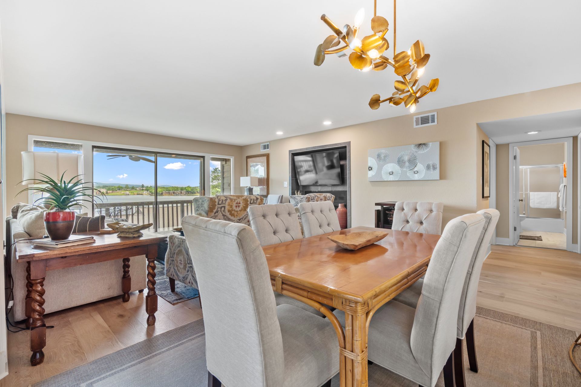 A dining room table and chairs in a living room.
