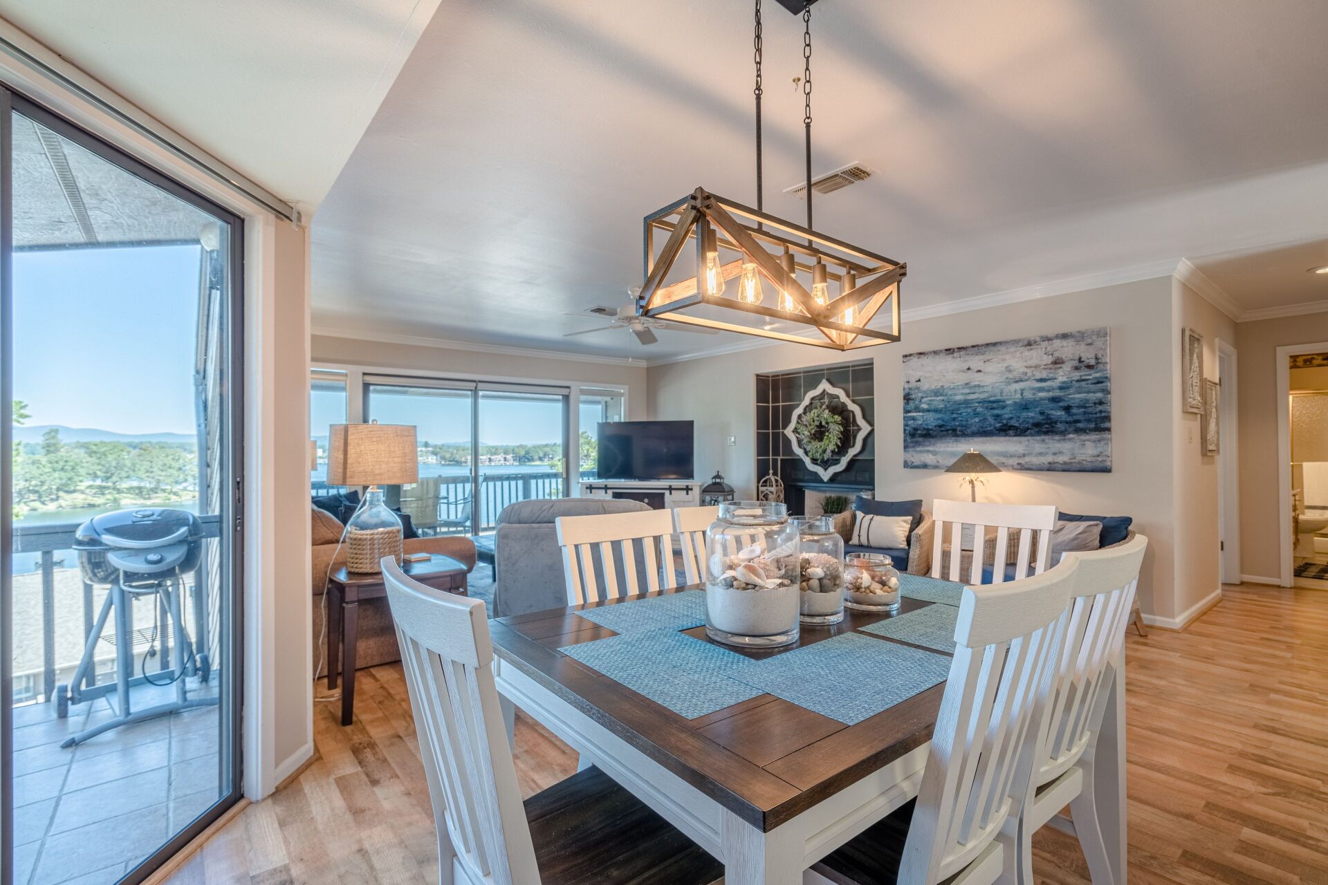 A dining room with a table and chairs and a chandelier.