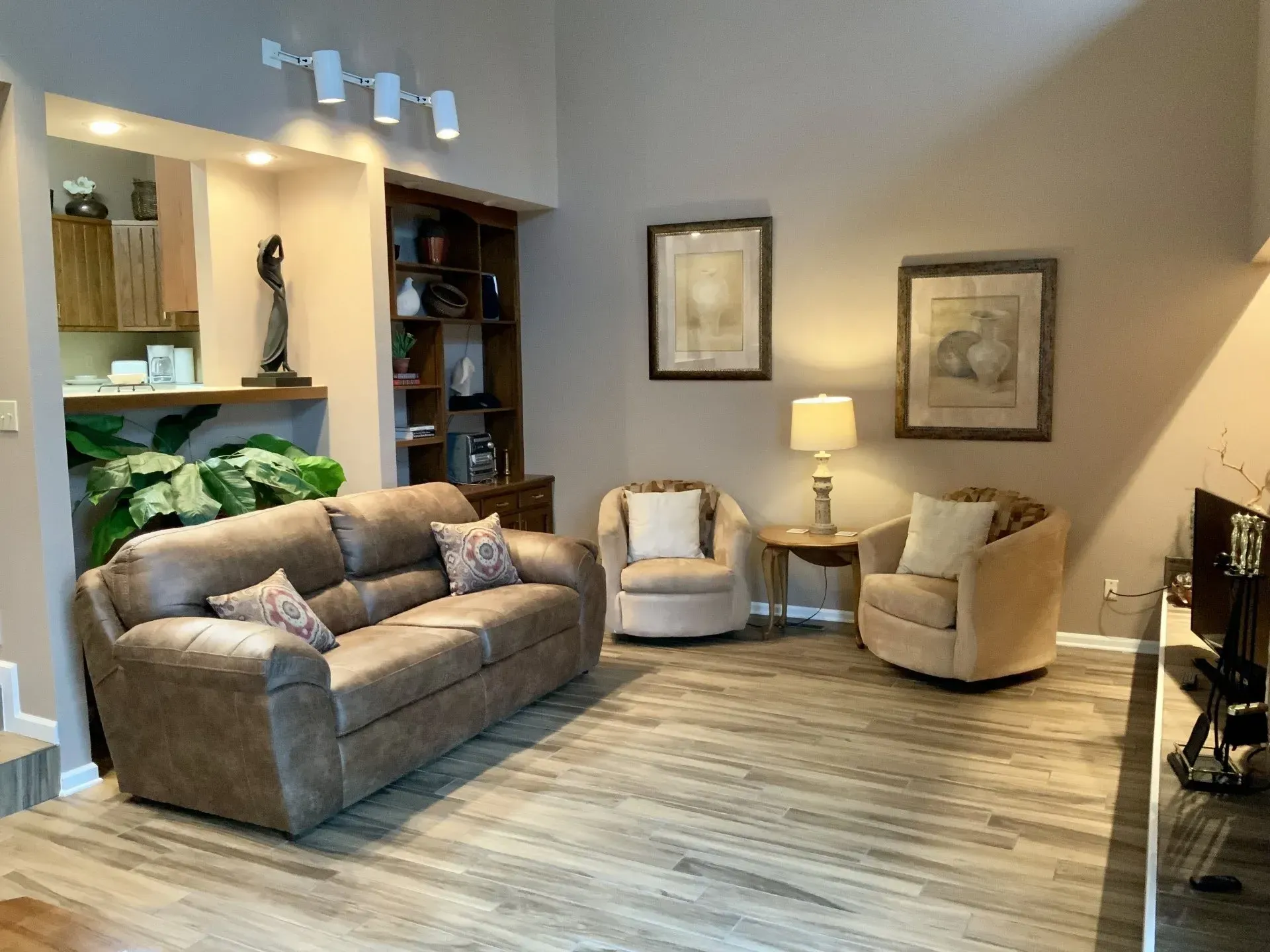 A living room with a couch and two chairs