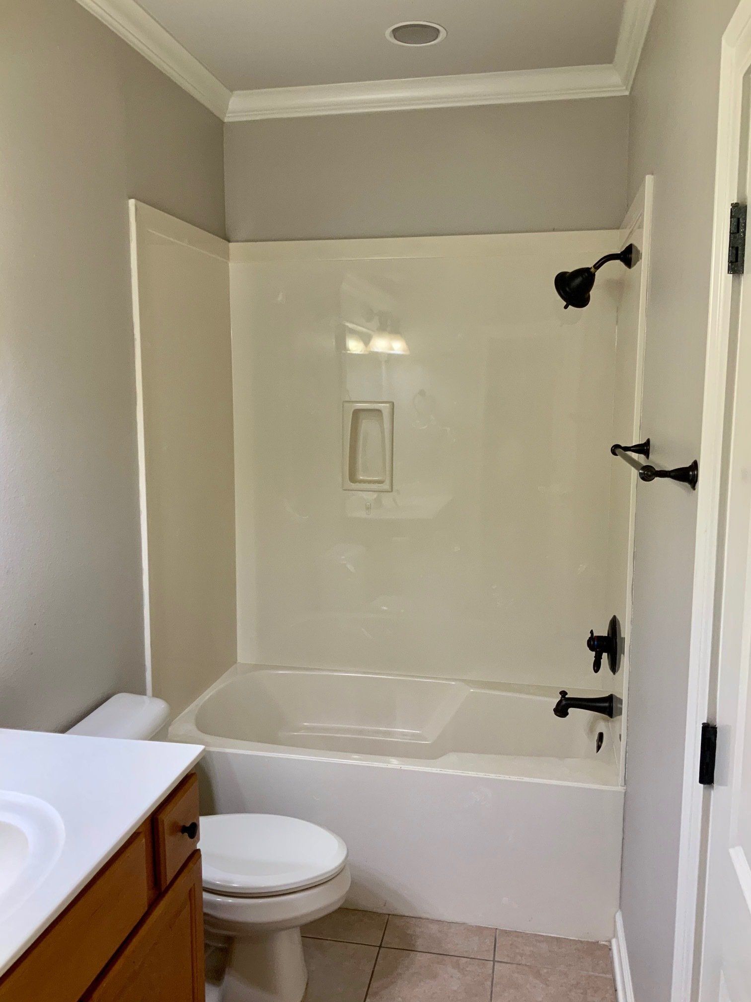 A bathroom with a toilet , sink , bathtub and shower.