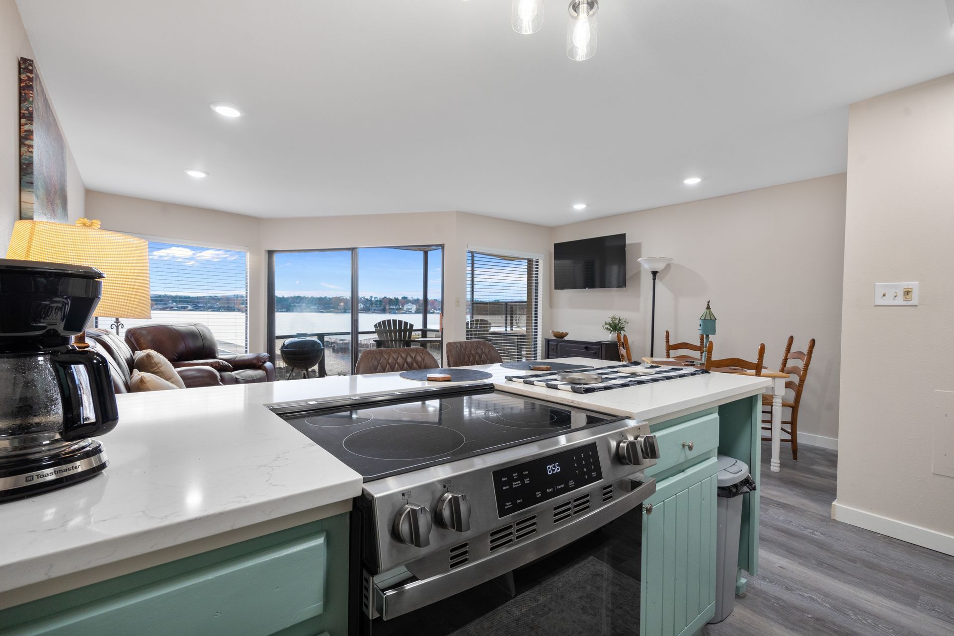 A kitchen with a stove and a coffee maker in it.