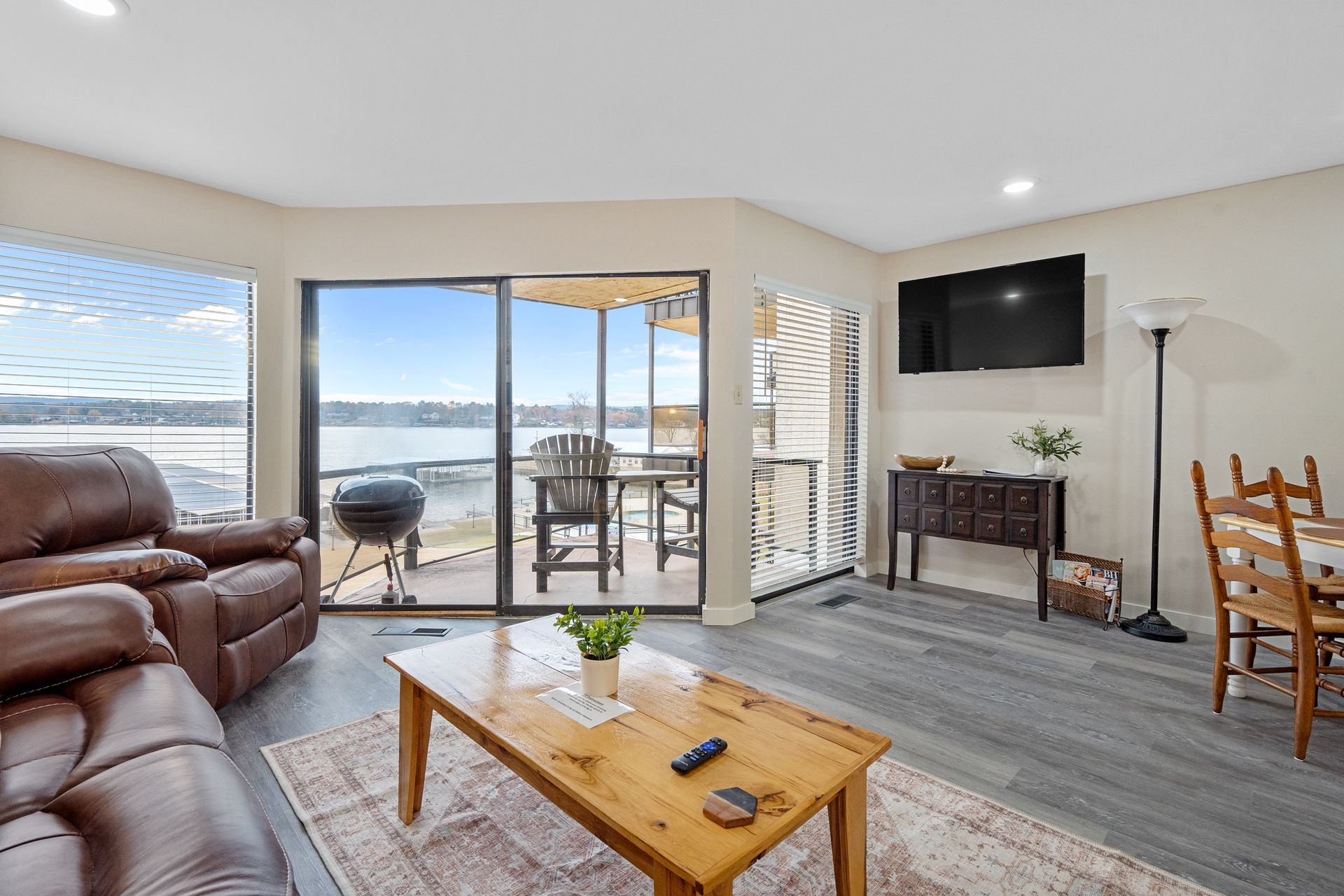 A living room with a couch , table , chairs and a television.