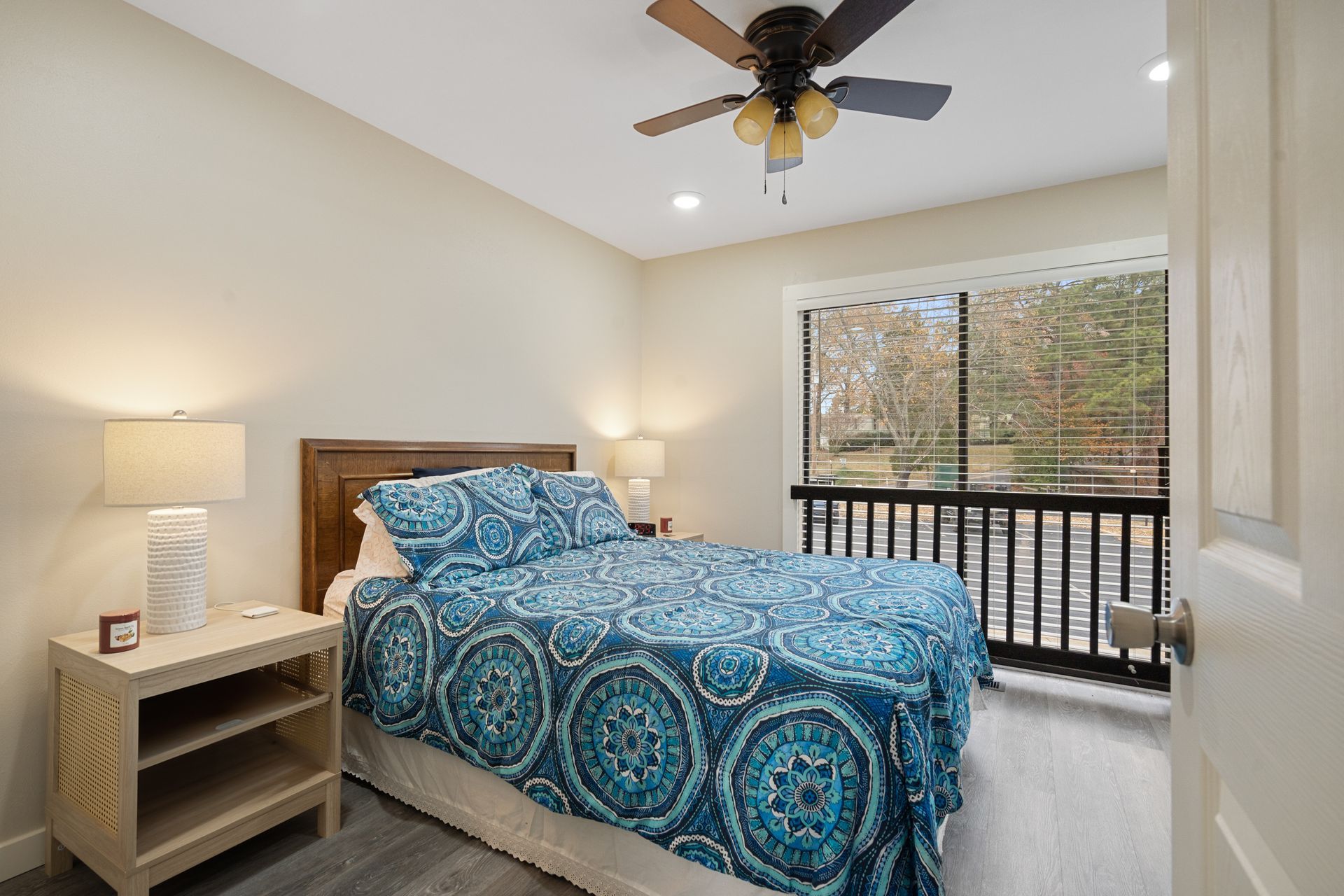 A bedroom with a king size bed and a ceiling fan.