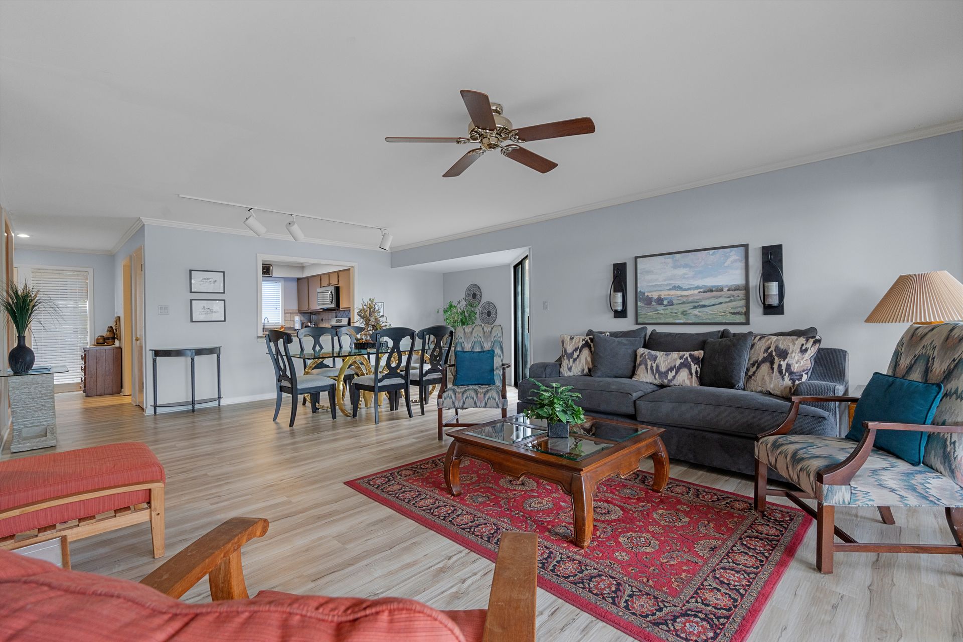 A living room filled with furniture and a ceiling fan.