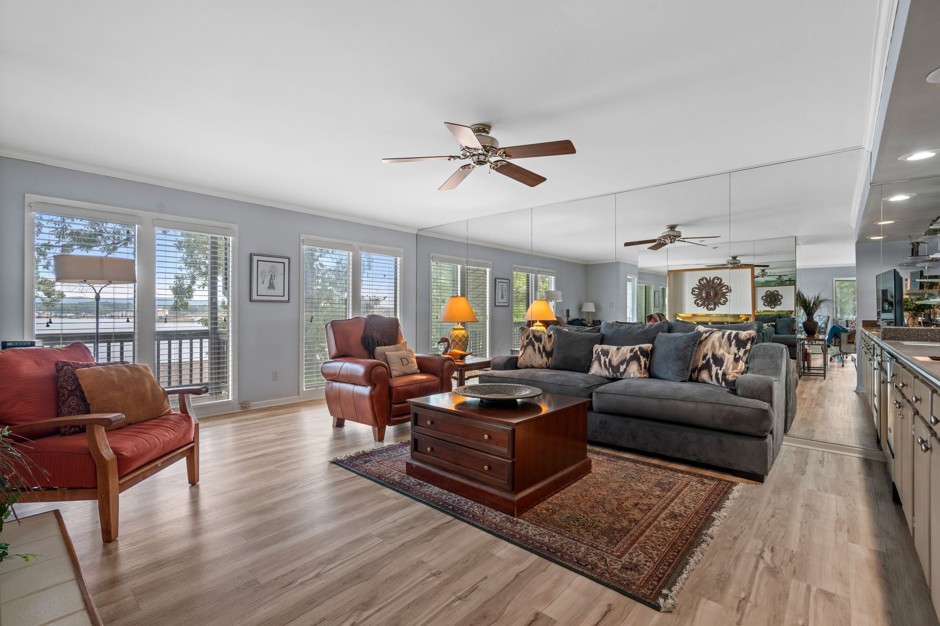 A living room filled with furniture and a ceiling fan.