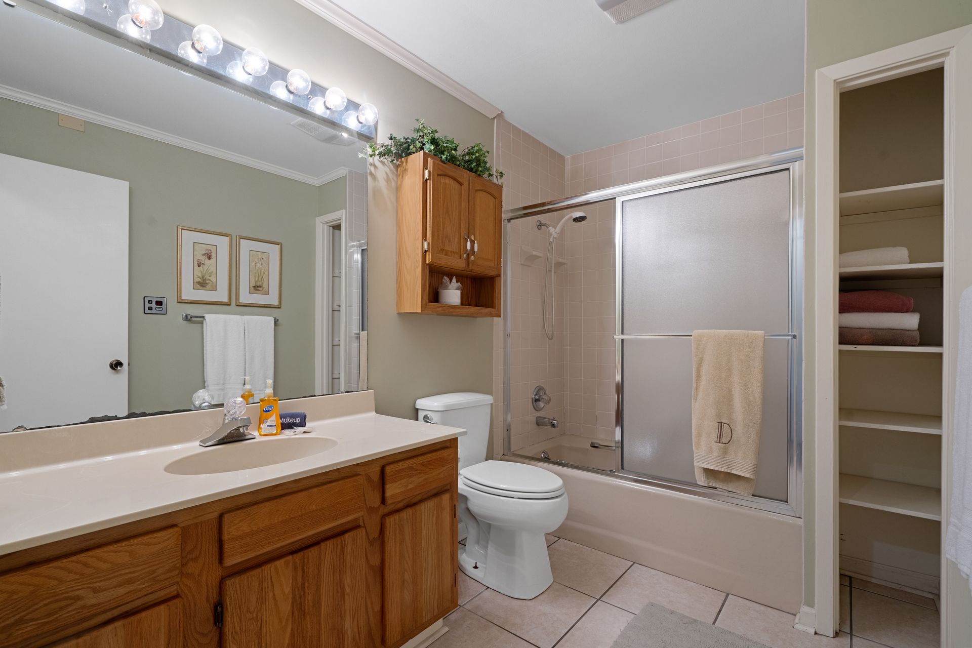 A bathroom with a toilet , sink , and shower.