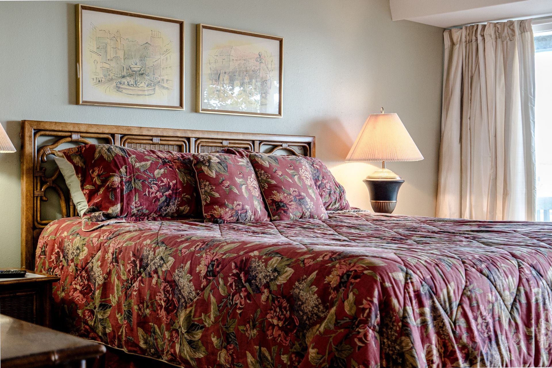 A bedroom with a large bed and two lamps