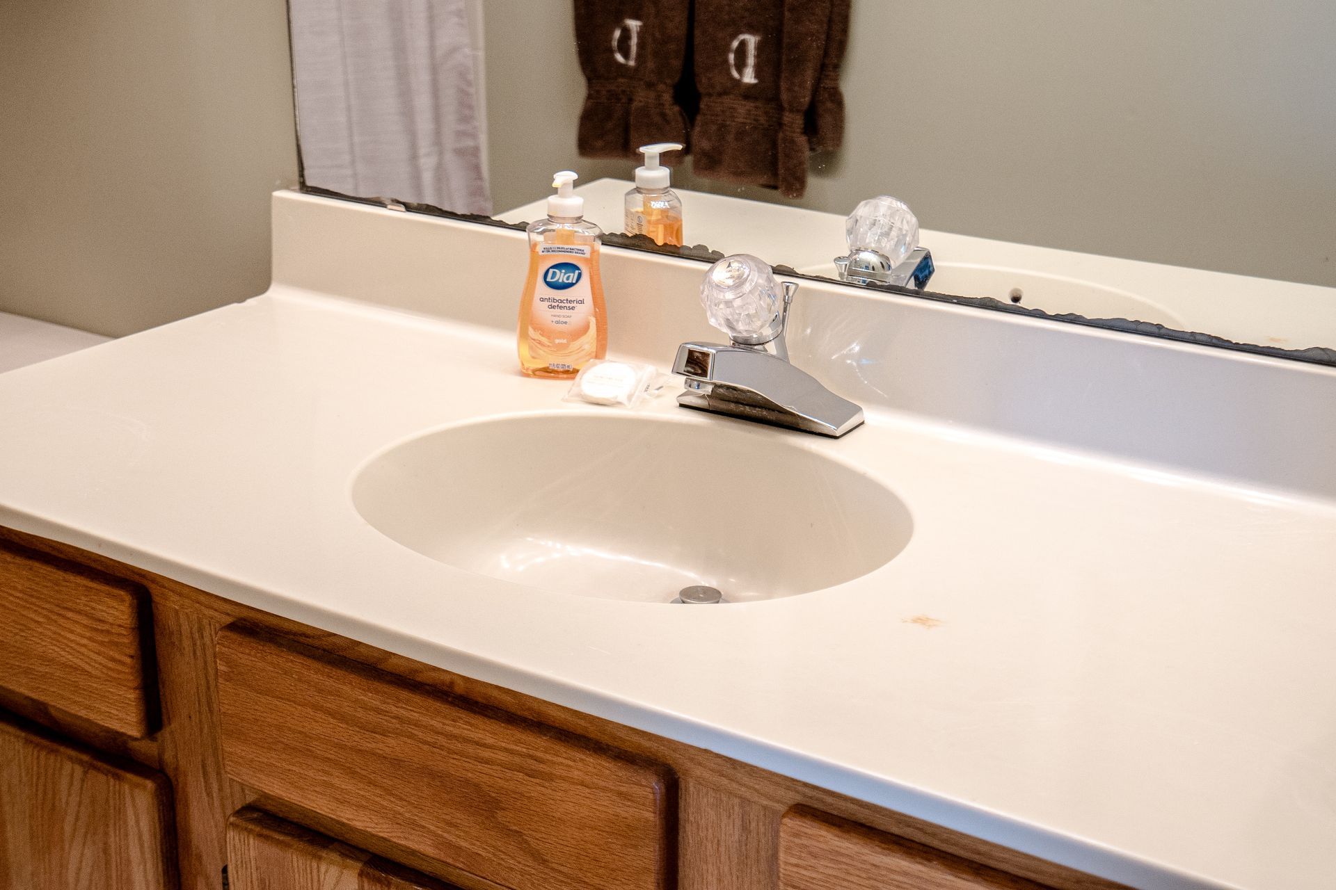 A bathroom vanity with a sink and a mirror.