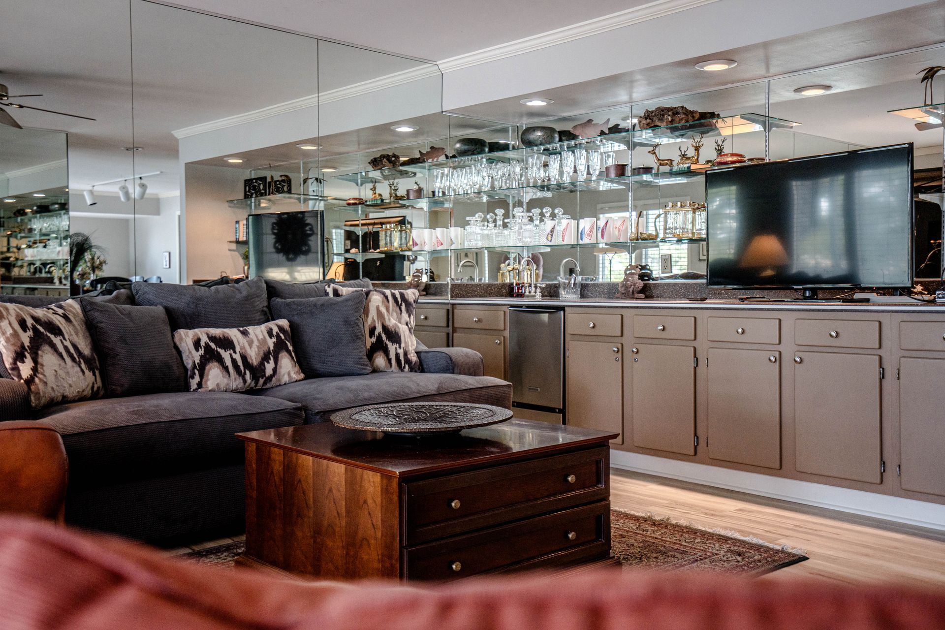 A living room with a couch , coffee table , and television.