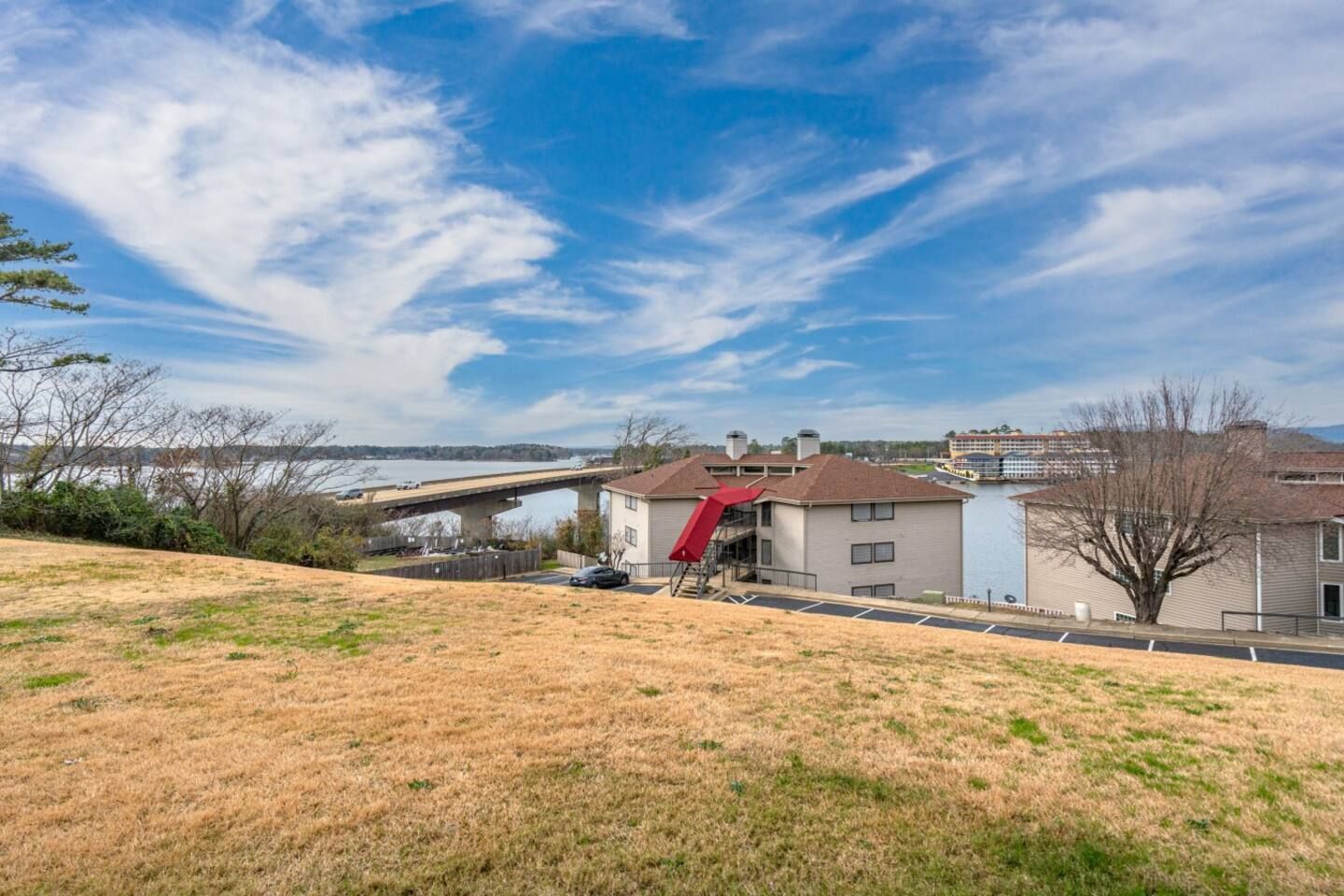 There is a bridge in the background and a house in the foreground.