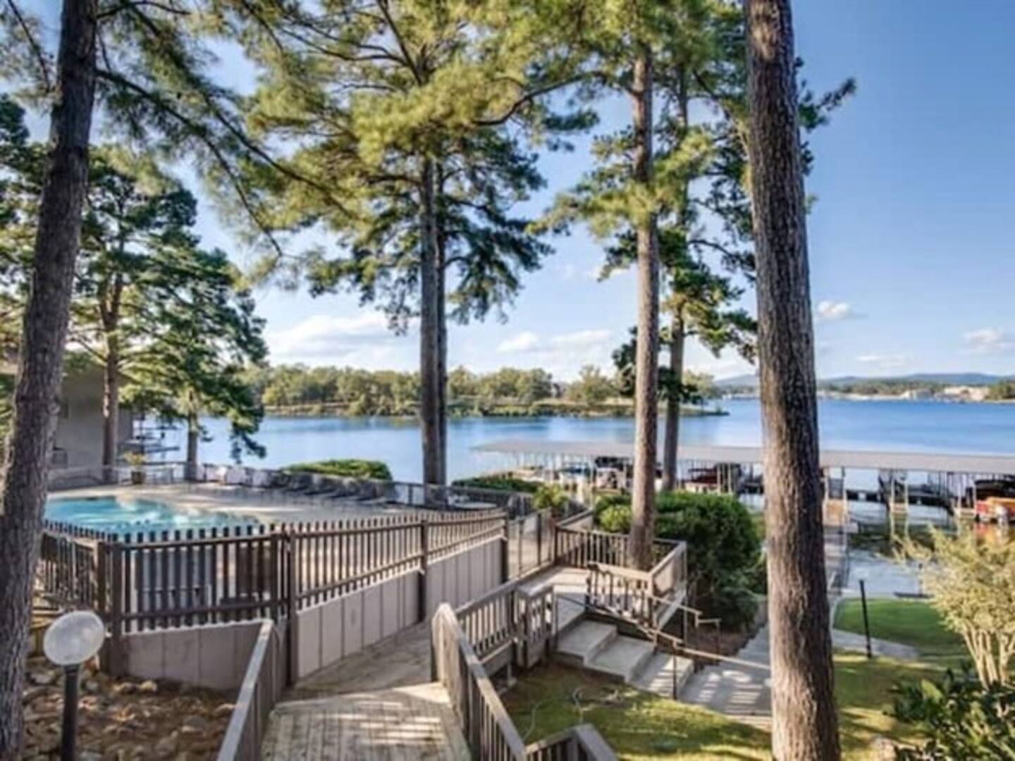 Stairs leading up to a swimming pool overlooking a lake