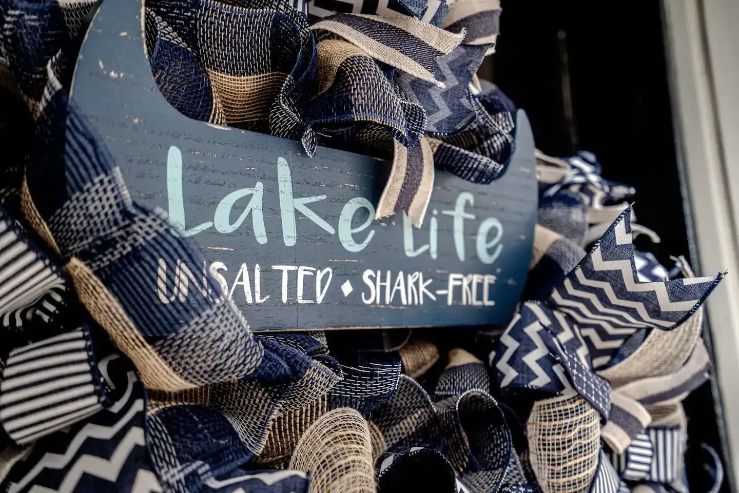 A wreath with a sign that says lake life is salted shark free