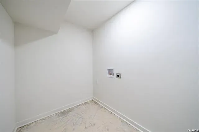 An empty room with white walls and a white floor.