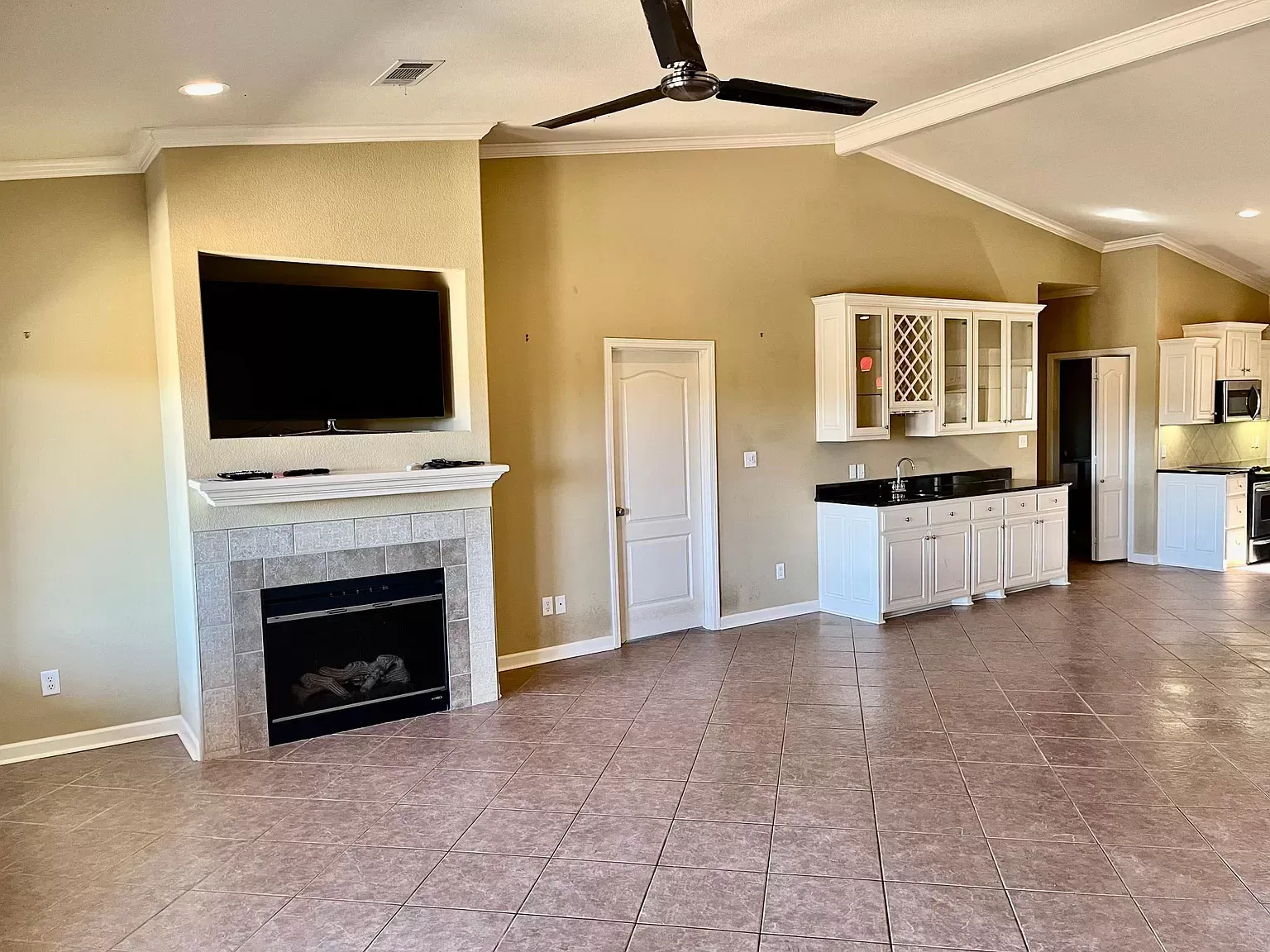 A living room with a fireplace and a flat screen tv