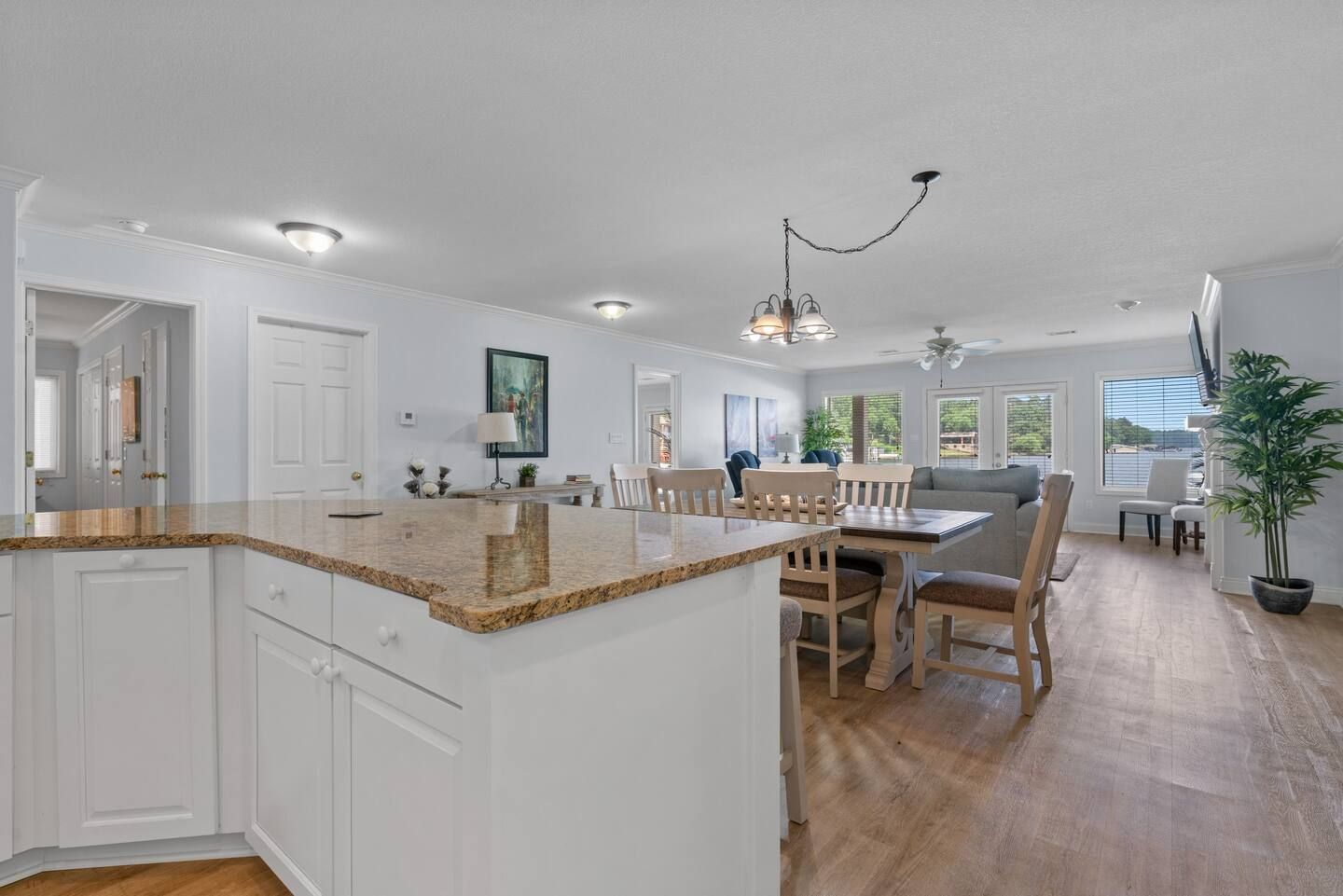 A kitchen and dining room in a house with a table and chairs.