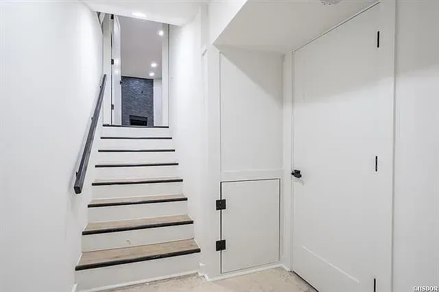 A hallway with stairs leading up to the second floor of a house.