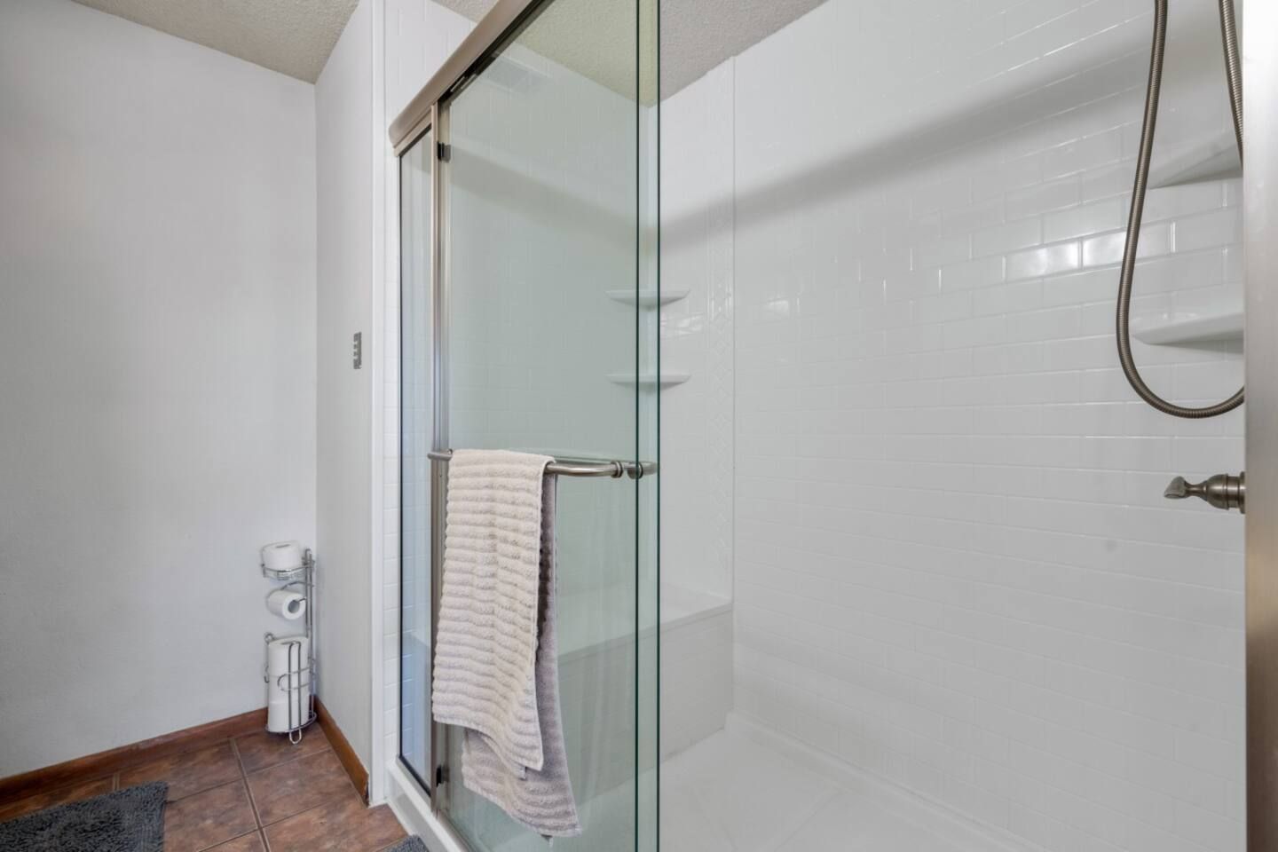 A bathroom with a walk in shower and a bathtub.