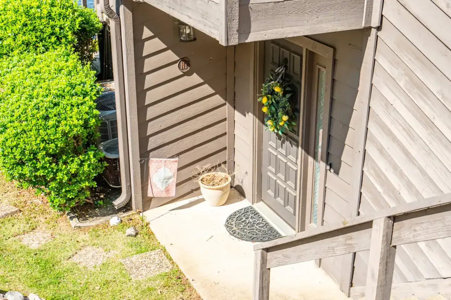 The front door of a house with a wreath on it.