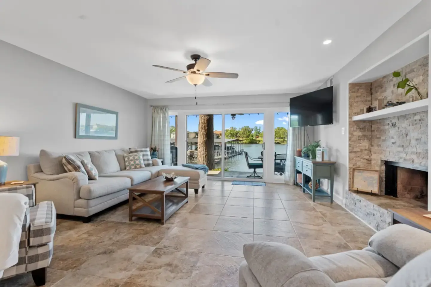 A living room filled with furniture and a ceiling fan
