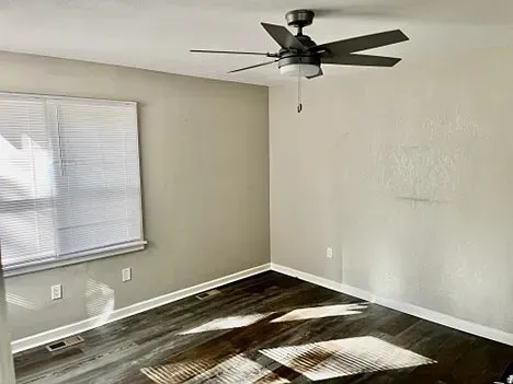 There is a ceiling fan in the corner of the room.