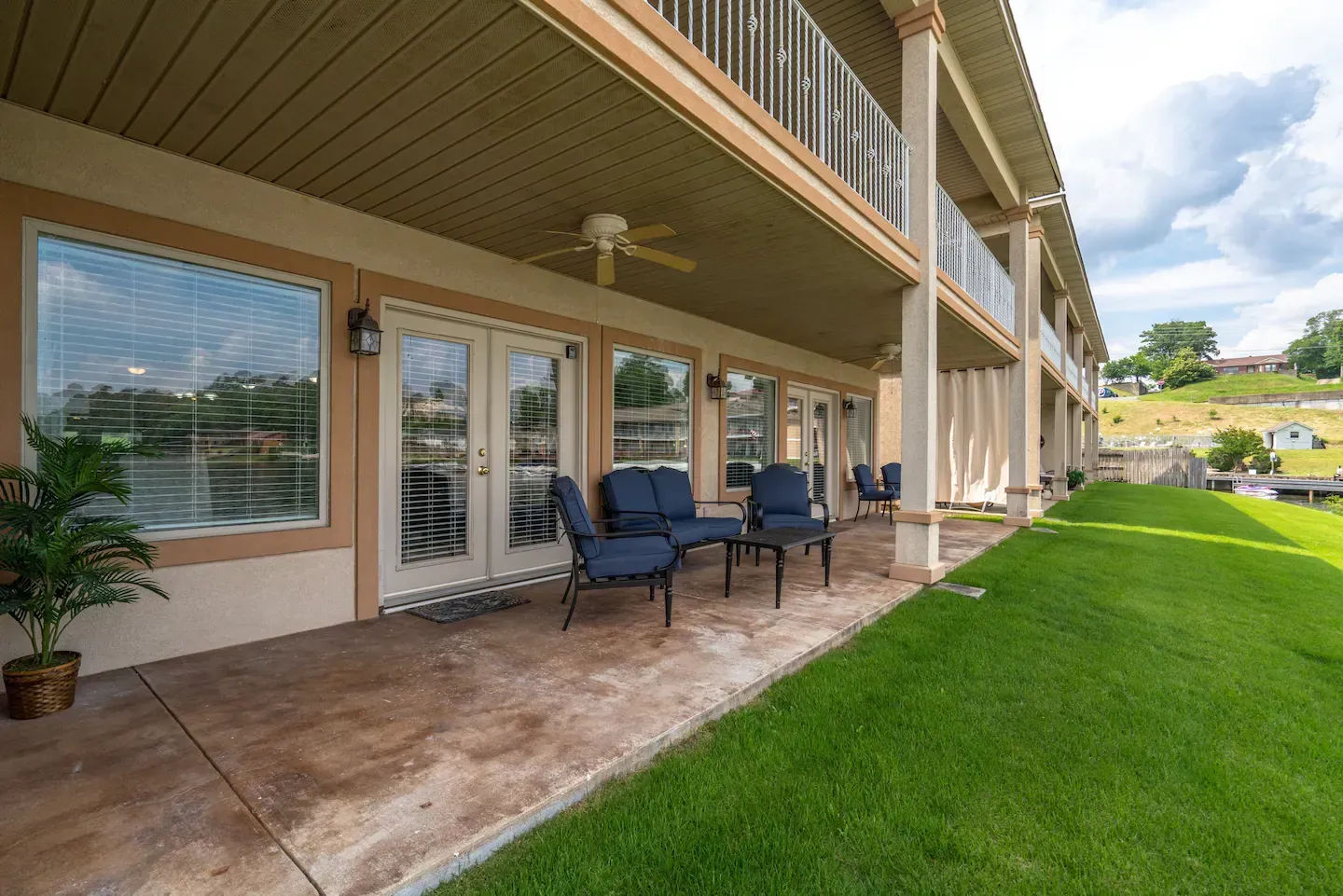 There is a large patio area with a lot of windows and chairs.