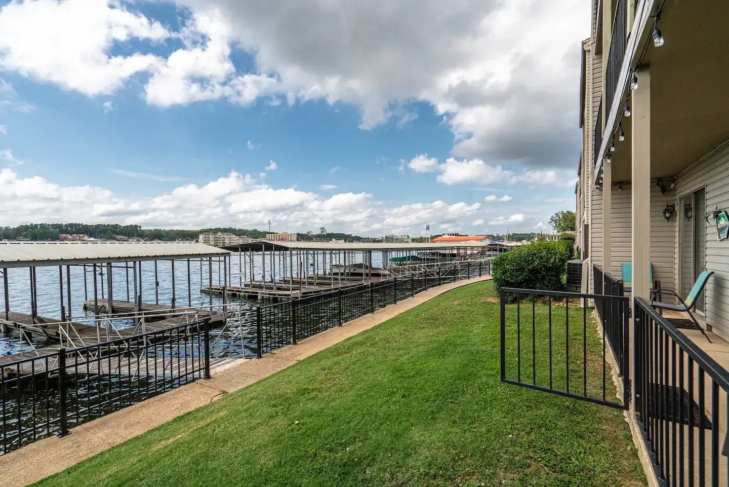 A fenced in yard with a view of a body of water.
