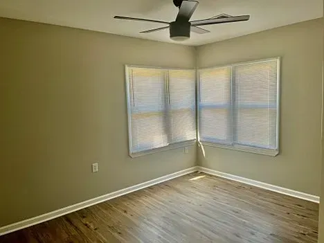 There is a ceiling fan in the corner of the room.