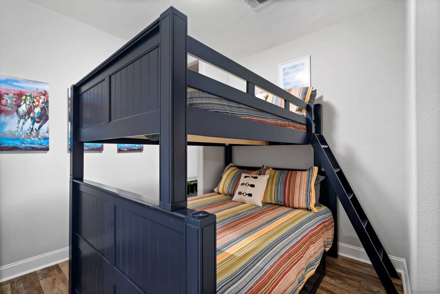 A bunk bed with a ladder in a bedroom.