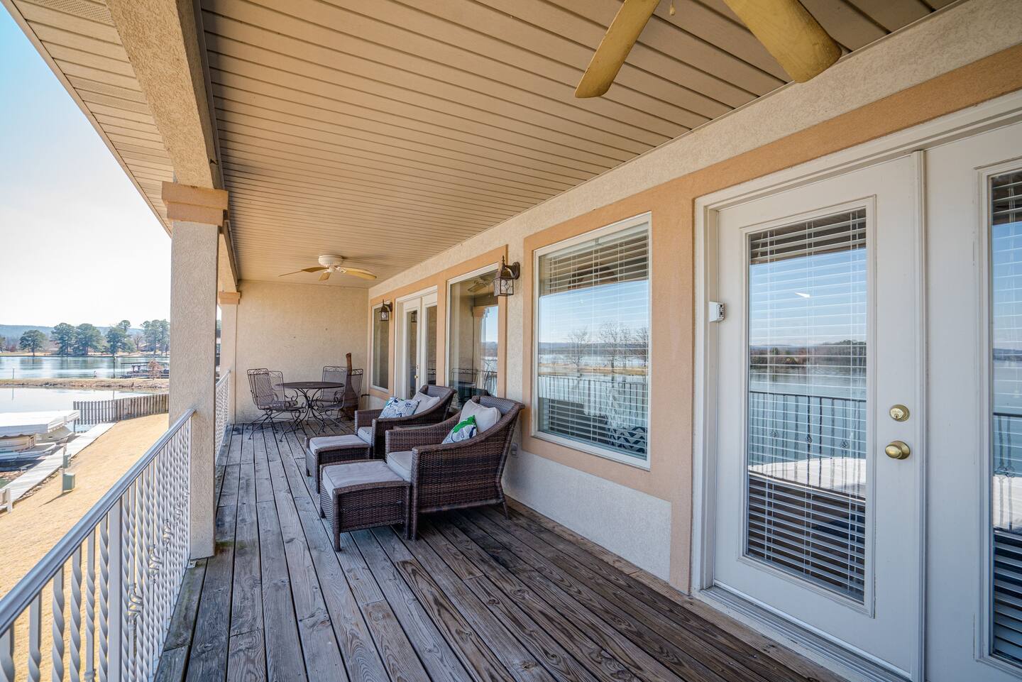There is a large balcony with a view of the water.