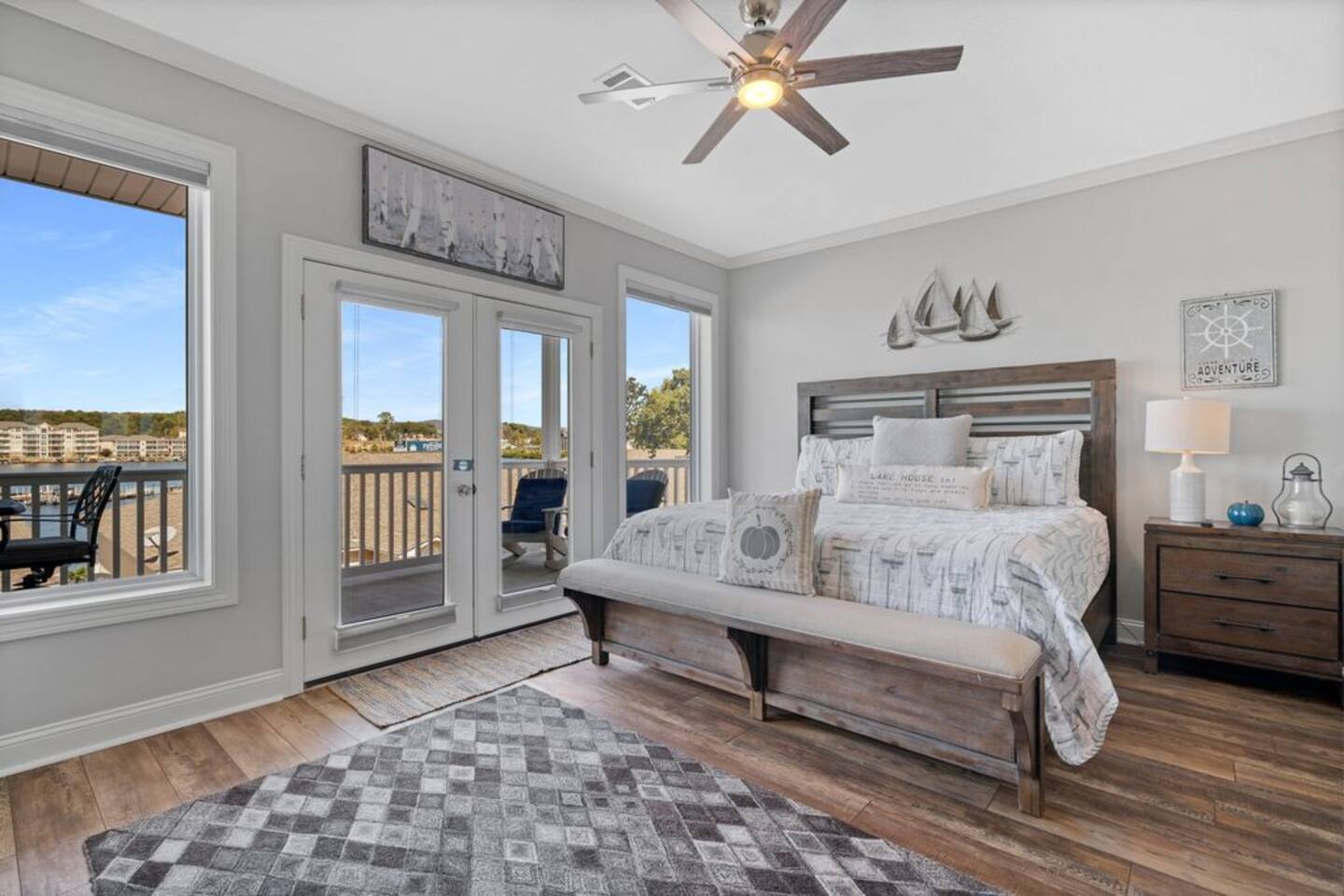 A bedroom with a king size bed and a ceiling fan.