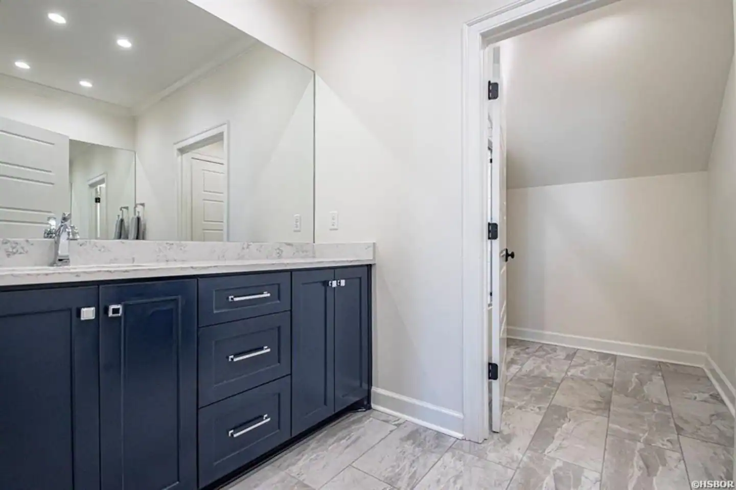 A bathroom with two sinks and a large mirror.