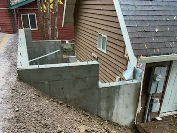 A house with a concrete wall in front of it