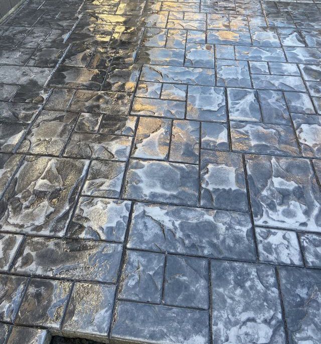 A close up of a brick walkway with a dirty side and a clean side