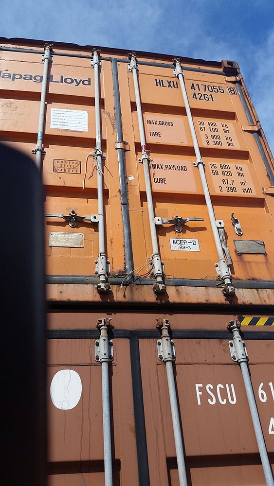 An Orange Shipping Container With Test On It — Oz Shipping Containers in Teralba, NSW